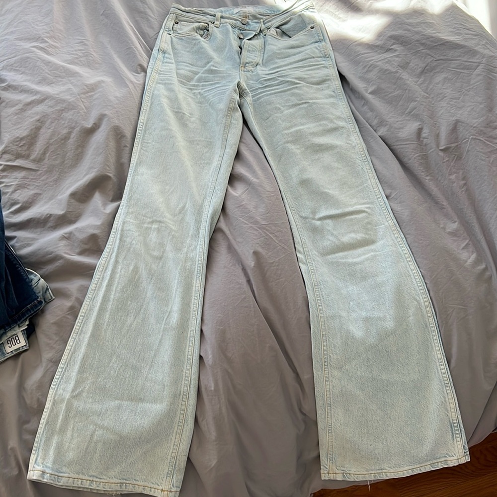 Boyish pale blue flare jeans with but detail